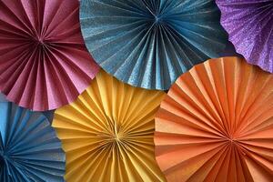 A colorful display of paper fans with glitter on them photo
