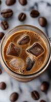 A mug of coffee with ice cubes in it photo