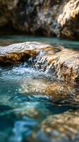 A rock is in the middle of a stream of water photo