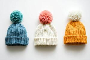 Colorful Knitted Winter Hats with Pom-Poms on White Background photo