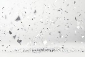 A white background with a lot of silver pieces scattered around photo