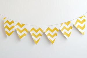 A yellow and white chevron banner hanging from a white background photo