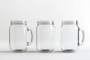 Three Transparent Glass Mason Jars with Handles on a White Background photo