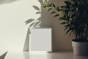Minimalist Interior with Blank Frame and Potted Plant Casting Shadows on Sunlit Wall photo