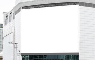Mock up white horizontal large billboard on tower building with blue sky background .Clipping path for mockup photo