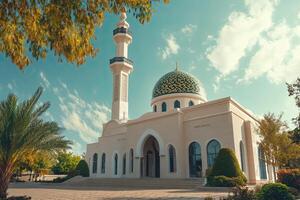 A white mosque with a green dome photo