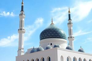 A white mosque with green domes and a blue sky photo