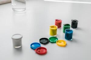 jars of gouache on windowsill - art painting and drawing lessons photo