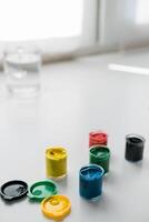 jars of gouache on windowsill - art painting and drawing lessons photo