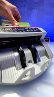 Blurred image of one hundred euro counted in the cash counting machine. Focusing on the banknotes video