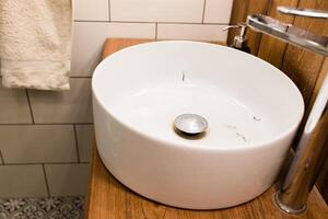 Water tap with dirty sink close up. chrome faucet wash basin. Hygiene and Cleaning hands and messy home concept. photo