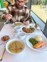 Hearty lunch served at a bright, modern cafe with a variety of dishes. Warm inviting atmosphere and delicious food create a perfect setting for a relaxed dining experience photo