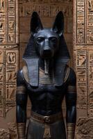 Black Anubis statue against ancient egyptian hieroglyphs background photo