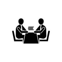 Two people sitting at a table with a book vector