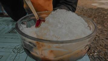 Close Up of Shaved Ice Dessert in Glass Bowl on a Table photo