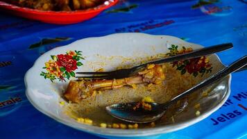 Empty Plate with Chicken Bones and Leftovers photo