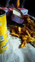 Crispy Fried Snacks on Paper with Can and Box photo