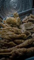 Fried Skewers and Crispy Snacks in Basket photo