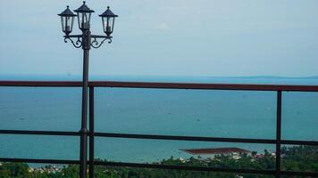 Scenic Ocean View from a Balcony with Lamp Post photo