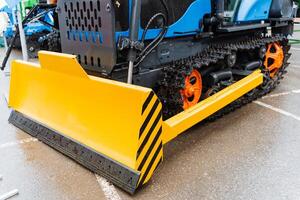 Bulldozer with asphaltstained tire parked on road side photo