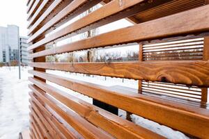 Close up of snowcovered wooden fence with hardwood planks photo