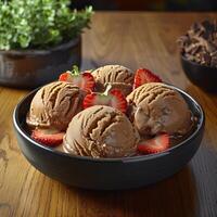 A close-up of a bowl of chocolate ice cream topped with strawberries photo