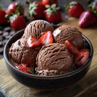 Close-up of a bowl of rich chocolate ice cream topped with fresh strawberries photo