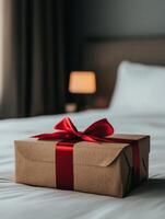 Beautifully wrapped gift on a neatly made bed in a cozy room photo