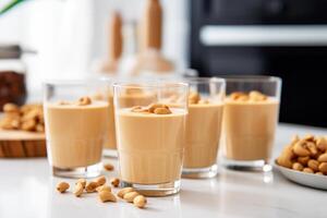 Peanut butter protein smoothie in glasses in white modern kitchen photo