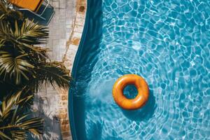 Aerial view of an orange float in a serene pool with palm tree accents photo