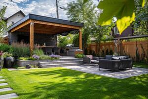 A backyard with a patio, lawn and a gazebo photo