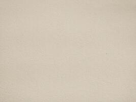Highresolution image of a neutral beige textured wall. Perfect for backgrounds, website design, or architectural presentations. Subtle texture adds visual interest without distraction. photo