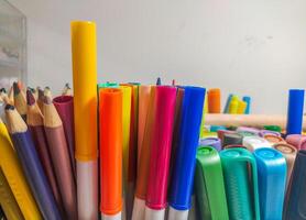 Closeup shot of colorful markers and pencils arranged together. Vibrant hues and textures create a visually appealing image perfect for education, art, or backtoschool themes. photo