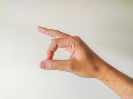 Closeup of a hand gesturing a small size or amount. Perfect for illustrating concepts of measurement, quantity, or comparison. photo