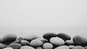 Serene Coastal Stones Smooth Grey Pebbles on a Misty Beach Background photo