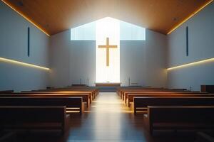 Sunlight shining through window behind cross in modern church photo