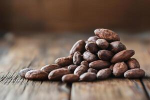 Roasted cocoa beans piled up on rustic wooden table photo