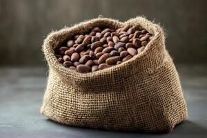 Burlap sack overflowing with aromatic cocoa beans photo