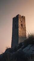 The ancient tower silhouette appears in a clean vertical frame, with a gradient sky and ample empty space around it. photo