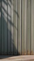 The vertical design of a minimalist fence casts gentle shadows, offering muted hues and ample space for text. photo
