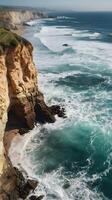 A vertical image of coastal cliffs with gentle waves beneath, an expansive sky, and plenty of room for text or overlays. photo