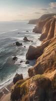 A vertical shot of coastal cliffs with soft waves below, open sky, and ample space for text or overlays. photo