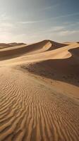 The vertical image features undulating sand dunes in warm light, with an open sky or gentle textures for adding copy. photo