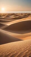 A vertical shot of soft, undulating sand dunes illuminated by warm light, leaving space in the sky or textures for text. photo
