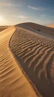 A vertical photo of smooth, flowing sand dunes bathed in warm light, with a blank sky or soft textures to allow for text placement.