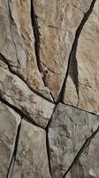 A vertical photo of natural rock textures in gentle, muted tones, creating a peaceful and spacious design vibe.