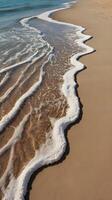 The close-up image captures gentle vertical wave lines on a peaceful beach, offering smooth textures and clear areas for text. photo
