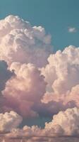 A vertical shot of elongated clouds stretching across a pastel sky, featuring a minimalist aesthetic and space for copy. photo