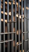 Evenly arranged metal bars with gentle lighting create a vertical composition with ample room for copy. photo