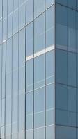 A vertical shot of glass windows capturing soft reflections, forming geometric designs with open areas for text. photo